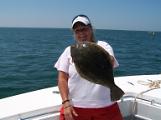 lady catching big flounder